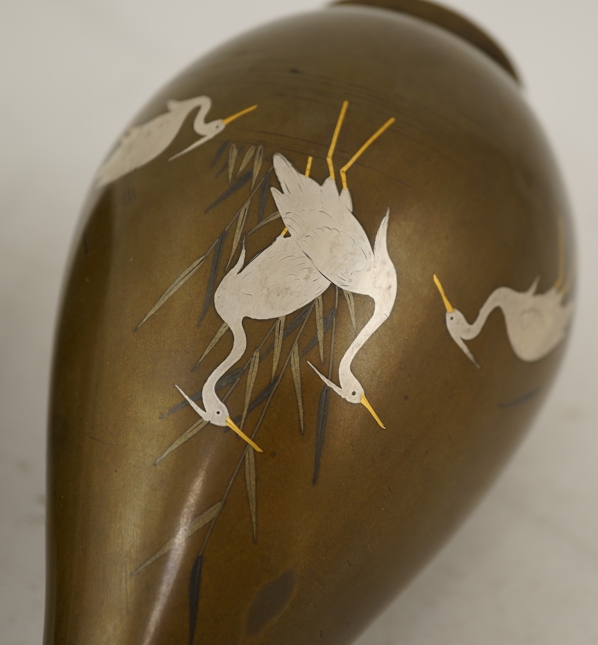 A pair of Japanese bronze and mixed metal inlaid bottle vases, signed Hidemitsu, Meiji period